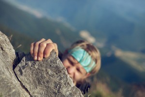 Young man finishing his extreme mountain climb