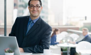 Smiling business man personalizing financial newsletter