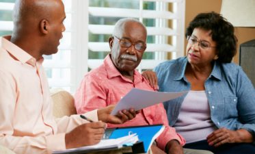 Financial Advisor Talking To Senior Couple about estate planning